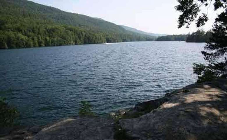 a wide open lake with the mountain in the background