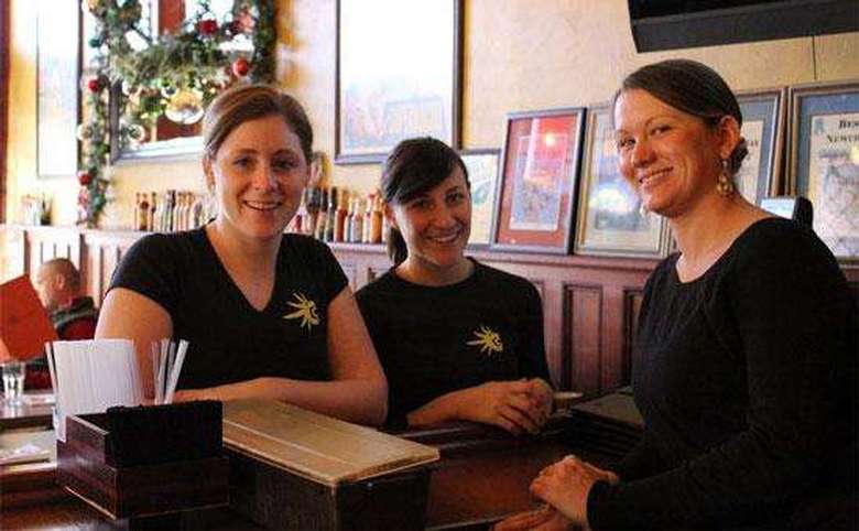 three cantina servers in black shirts