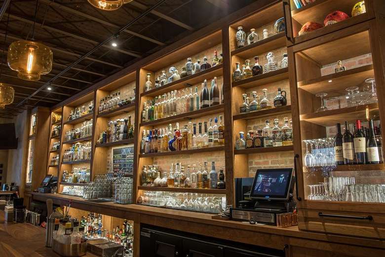 bottles on wall behind a bar