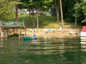 person in rowboat rowing away from the property