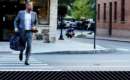 a sharply dressed man crossing the street